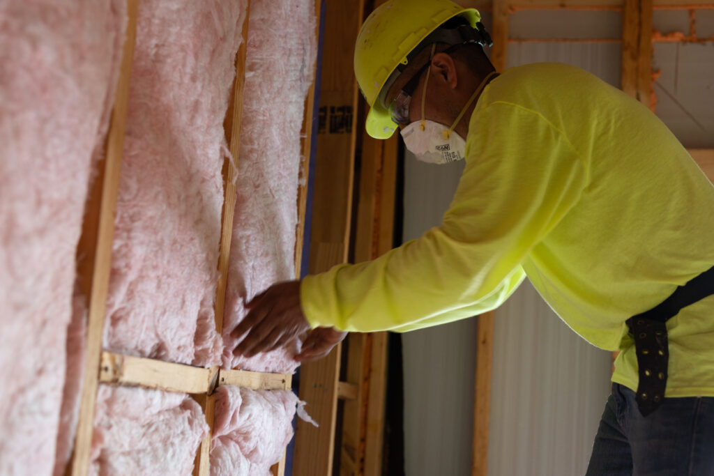 CLS technician installing insulation